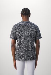Puma ANIMAL RELAXED TEE - Triko s potiskem - black