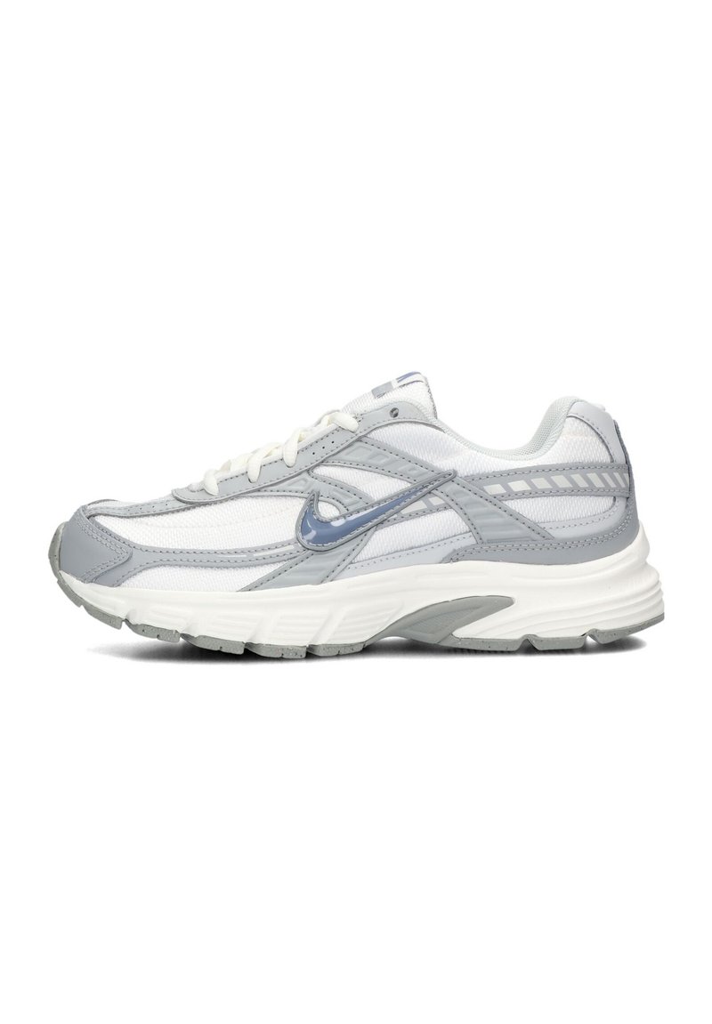 Nike running shoe featuring a mix of grey and white mesh material, with a textured sole, and reflective accents on the sides.