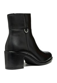 Stivaletto in pelle nera con punta arrotondata, tacco basso a blocco e elementi decorativi in argento sui lati. Finitura liscia su tutta la superficie.