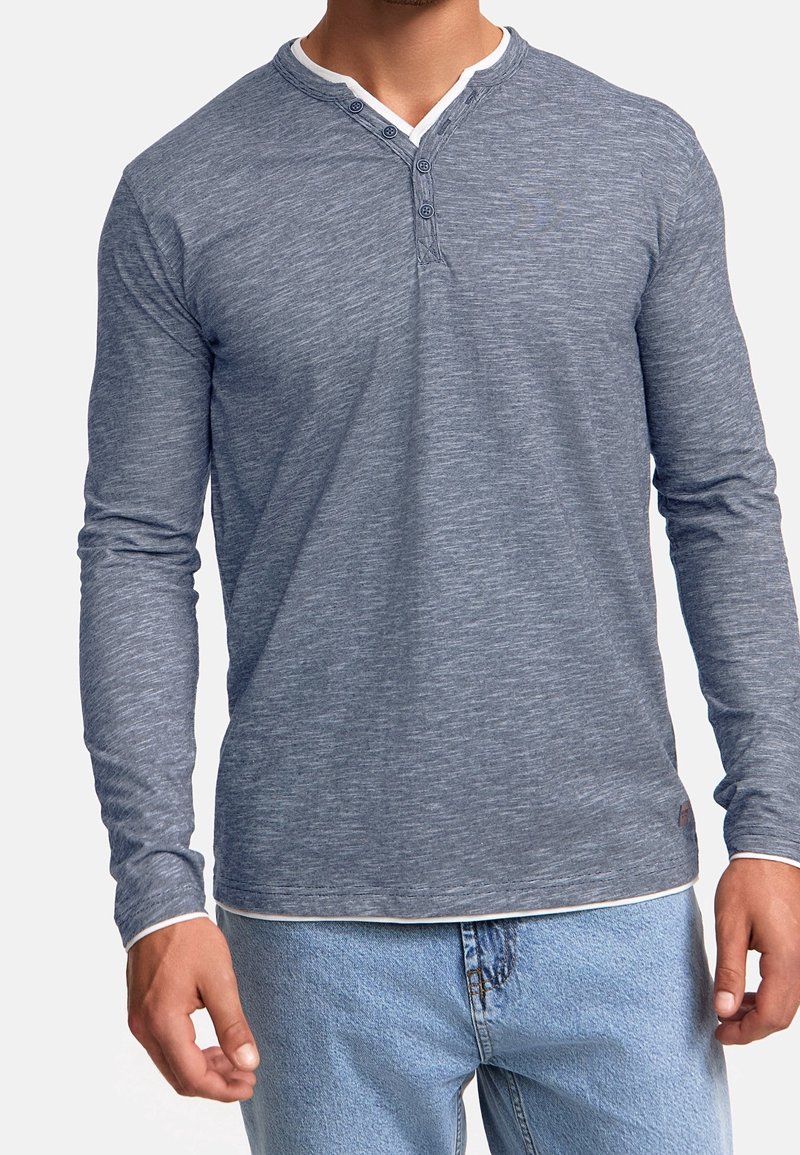 Long-sleeve henley shirt in heathered blue fabric, featuring a white collar, three buttons at the neckline, and a fitted cut.