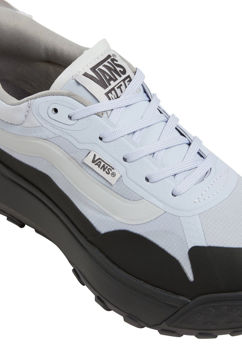 Zapatilla Vans MTE azul claro y negra con cordones blancos, collar de espuma y suela texturizada, mostrando detalles laterales y superiores.