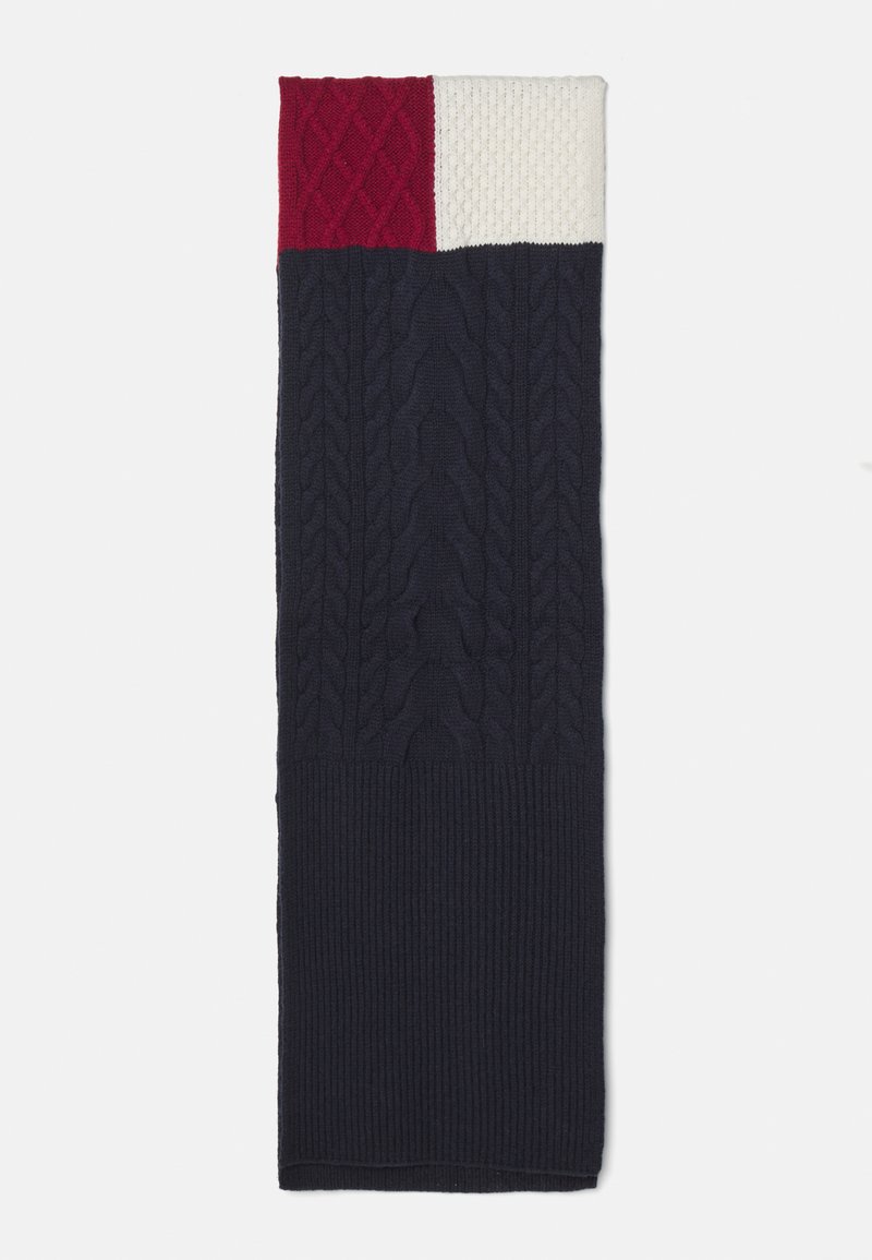 Knit scarf featuring navy, red, and white sections. Textured cable knit design at the top, ribbed texture at the bottom.