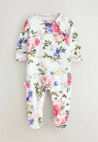 Balti kūdikio bodži su ilgomis rankovėmis, padengtas spalvinga gėlių ir drugelių raštu, su mažomis kaspinėlių detalėmis ant kiekvienos kojytės.