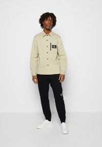 Calvin Klein Jeans TWO TONE MONOGRAM PANT - Pantaloni sportivi - black