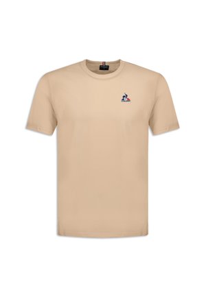 Beige cotton t-shirt with a crew neck and short sleeves. Features a small embroidered logo on the left chest. Soft, smooth texture.