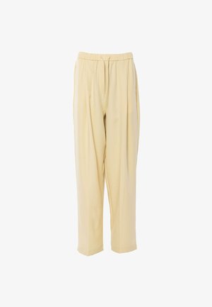 Béžové volné kalhoty s elastickým pasem a šňůrkou, mají rovné nohavice a skryté boční kapsy.