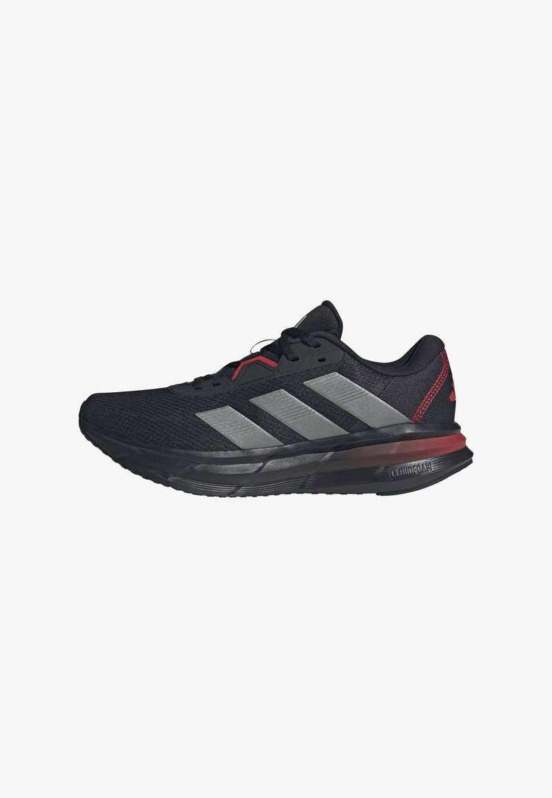Black athletic shoe with mesh upper, silver three-stripe design, red accents, and a thick black sole with Cloudfoam technology for cushioning.