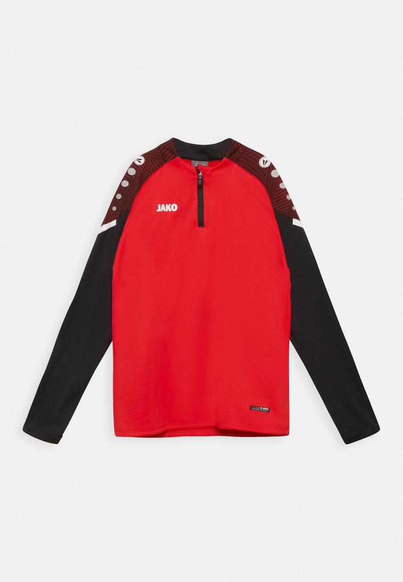Rode sporttop met lange mouwen, zwarte onderkant, rits tot kwart nek en contrasterend schouderontwerp met stippen. Logo "JAKO" op de voorkant.