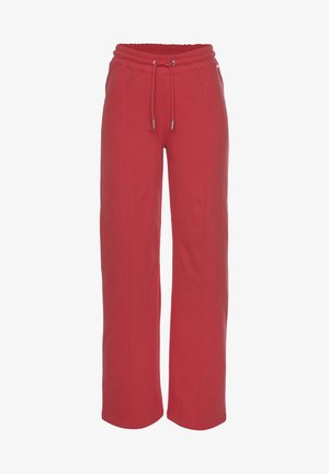 Rode joggingsbroek van zacht materiaal, met een elastische tailleband met trekkoord, wijde pijpen en contrasterende stiksels langs de zijkanten.