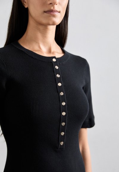 Black ribbed short-sleeve dress features a round neckline and a button placket with round, shiny buttons down the front.