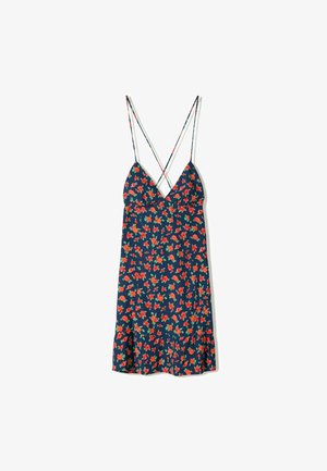 Sømløs kjole med dyb V-udskæring, der har en mørkeblå baggrund og et blomsterprint i rød og grøn. Volangkant og tynde krydsede stropper.