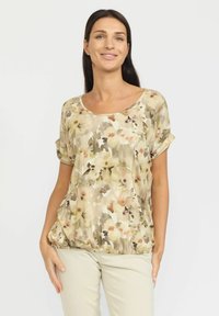 Blomsterpryntet, kortermet topp i beige, med rundet utringning og samlet hem for en avslappet passform.