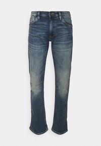 Jeans z denimu w ciemnoniebieskim kolorze z wyblakłym wykończeniem, slim fit, pięć kieszeni, wzmocnione szwy i delikatne poszerzenie przy kostkach.
