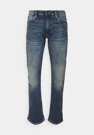 Jeans z denimu w ciemnoniebieskim kolorze z wyblakłym wykończeniem, slim fit, pięć kieszeni, wzmocnione szwy i delikatne poszerzenie przy kostkach.