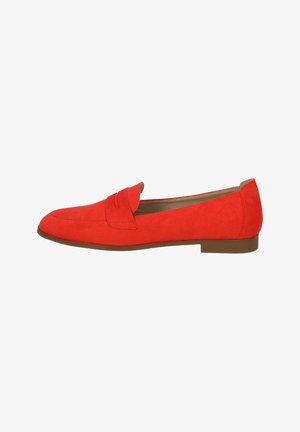 Red suede loafers with a flat sole, featuring a decorative seam detail and a slightly rounded toe. Smooth texture and minimalist design.