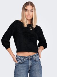 Black fuzzy crop sweater with long, slightly puffed sleeves. Paired with light blue high-waisted jeans featuring faded details and pockets.
