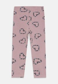 Rosa barnelegginger med mønster av svarte og hvite blomsterhjerter over hele stoffet, laget av elastisk materiale.
