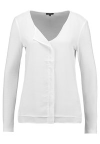 Blusa bianca a maniche lunghe con chiusura anteriore asimmetrica e colletto a V, taglia piccola, realizzata in tessuto leggero.