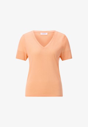 Pfirsichfarbenes Damen-V-Ausschnitt-Oberteil mit kurzen Ärmeln, gerippten Ärmelbündchen und einem Markenschild am Halsausschnitt.