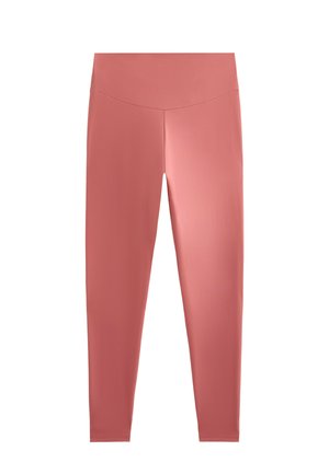 Legginsy w delikatnym odcieniu różu, wykonane z elastycznego, gładkiego materiału. Wysoka talia, dopasowany krój bez widocznych wzorów ani elementów metalowych.