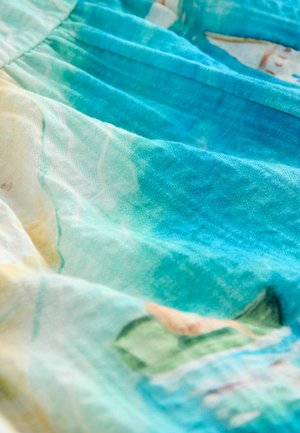 Lightweight fabric with a blue-green ombre effect, featuring abstract patterns in soft tones of yellow and beige. Fine texture, pleated design.