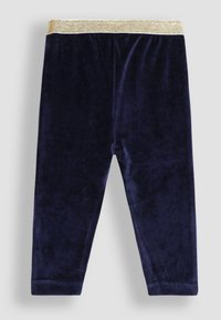 Navyblauwe fluwelen legging met een glanzende gouden elastische tailleband. Zachte textuur en een aansluitend ontwerp, geschikt voor comfortabel dragen.