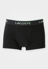 Zwarte katoenen boxershorts met een aansluitend ontwerp, voorzien van een mintgroene elastische tailleband met het "LACOSTE" logo en een opening aan de voorkant.