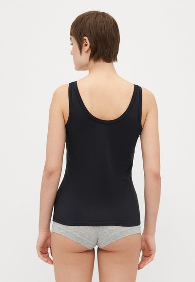 Black sleeveless top made of smooth fabric with a rounded neckline and a fitted design, paired with gray cotton shorts.
