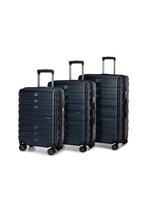 Three navy hard-shell suitcases in varying sizes with horizontal ridges, extendable handles, and four swivel wheels for easy maneuverability.