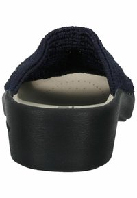 Scarpa slip-on in tessuto blu navy con una parte superiore testurizzata e suola in gomma nera. Presenta una forma sagomata e sottili perforazioni sulla soletta.