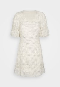 Vestido blanco con lunares negros, mangas cortas abullonadas, escote en V, tela texturizada y diseño en capas. Silueta fluida.