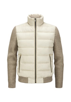 Puffer jacket with a high collar, featuring a cream front and textured brown knit sleeves. Two zippered side pockets.
