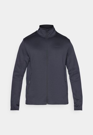 Mørk grå zip-up jakke laget av mykt stoff, med høy krage, lange ermer og sidelommer med glidelåslukking.