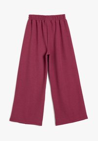 Pantalones de pierna ancha en color marrón burdeos, confeccionados con una tela suave y con una cinturilla elástica, que cuentan con un corte relajado y bordes de dobladillo limpios.