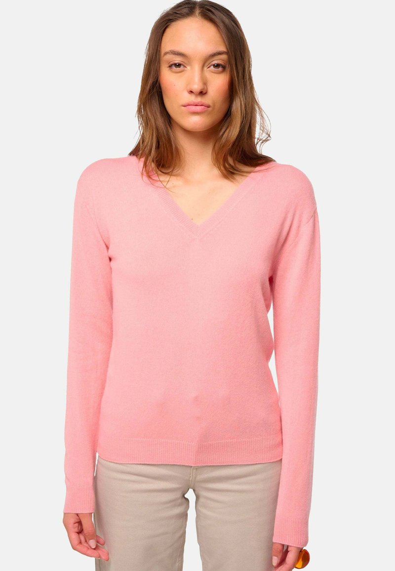 Pull rose en V, avec des manches longues, texture douce et ourlet côtelé. Fabriqué en matériau léger, idéal pour le superposition.