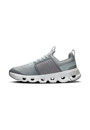 Light grey sneakers with mesh and solid fabric, featuring a thick white sole with cutouts and a gray side panel. Includes laces and heel tab.