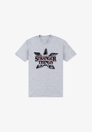 Graues Baumwoll-T-Shirt mit einem schwarzen und roten "Stranger Things"-Logo und einem abstrakten Stern-Design. Kurze Ärmel und Rundhalsausschnitt.