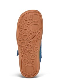 Blue sandal sole with textured, tan rubber, featuring a pattern of varied geometric shapes for traction and grip.