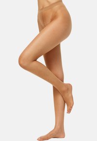 Collant trasparenti color pelle con texture liscia e punta rinforzata. Presentano una vita comoda e un aspetto naturale della tonalità della pelle.