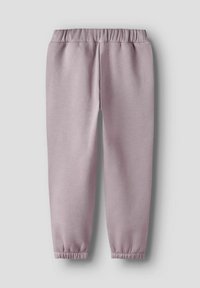 Pantalons de survêtement rose clair en tissu doux, avec une taille élastique et des poignets resserrés, présentant une texture lisse et un design fuselé.