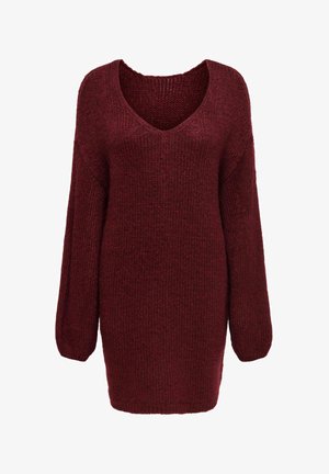 Viininpunainen neulepusero V-kaula-aukolla, pitkillä hihoilla ja väljällä istuvuudella. Siinä on teksturoitu kuvio ja resorit hihansuissa ja helmassa.