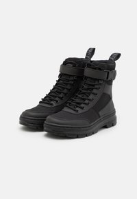 Black high-top boots with a sturdy rubber sole, textile upper, reinforced toe, and adjustable strap around the ankle. Laced design with pull tabs.