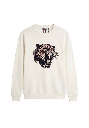 Sudadera de manga larga color crema con un gráfico detallado en el pecho de una cabeza de tigre rugiente en negro y marrón, cuello redondo y puños acanalados.