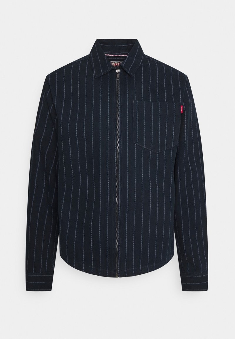 Navy blue zip-up jacket with vertical white stripes, featuring a collared neck, long sleeves, and a chest pocket.