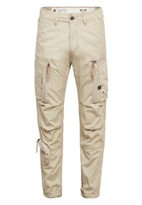 Beige cargo kalhoty s více zipovými kapsami, poutky na opasek, knoflíkovým zapínáním a štítkem velikosti 32x32 uvnitř pasu.