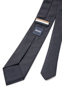 Navy blue tie with a textured herringbone pattern. Features a "BOSS" label and a small tri-color accent ribbon near the tip.