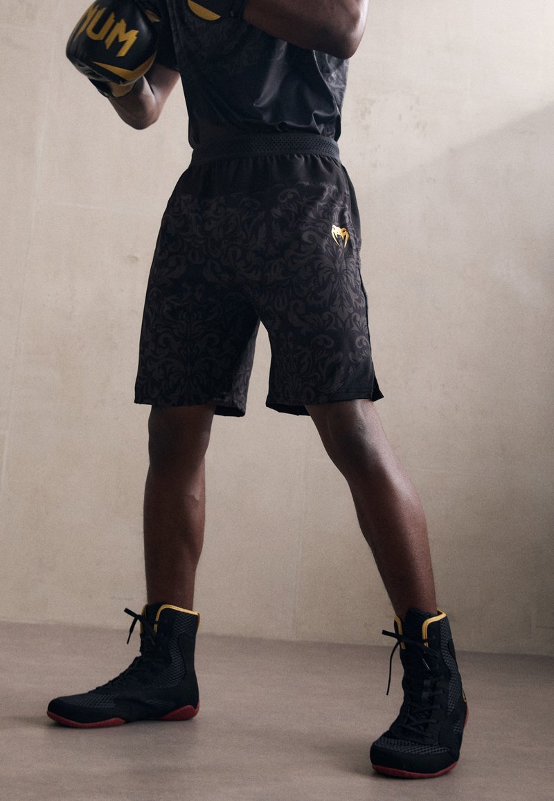 Venum - UNMATCHED TOPURIA EDITION TRAINING SHORTS - Sports shorts - black/antique gold, Enlarge