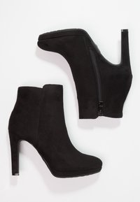 Musta mokkanahkainen nilkkaboot, jossa on terävä kärki, korkea stiletto-korko ja sivu-zipper suljettuna. Sileä pinta ja minimalistinen muotoilu.