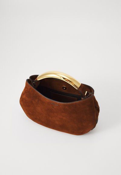 Brown suede handbag with a curved gold handle and an interior pocket. The design features a soft texture and a simple, modern shape.