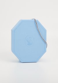 Light blue octagonal box made of textured material, featuring a logo and a silver chain with circular embellishments.